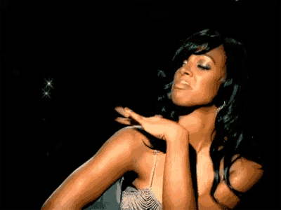 a woman in a dress is dancing in a dark room