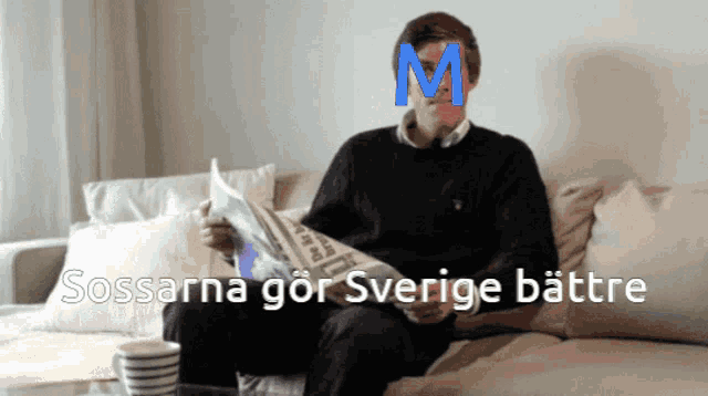 a man sitting on a couch reading a newspaper with the letter m on his head