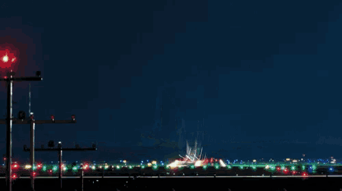 a plane is taking off from an airport at night