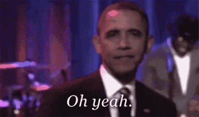 a man in a suit and tie is smiling and says oh yeah