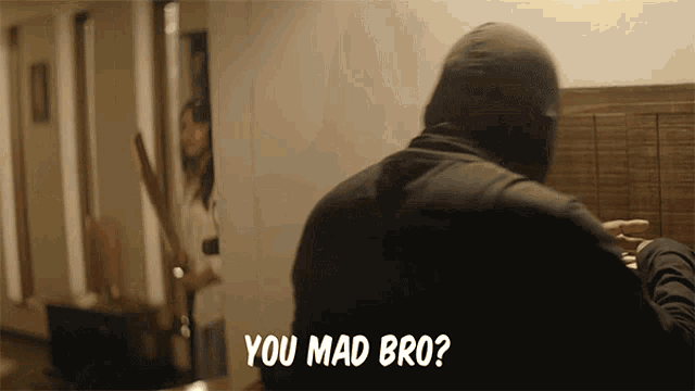 a man in a mask says " you mad bro " in front of a woman holding a knife