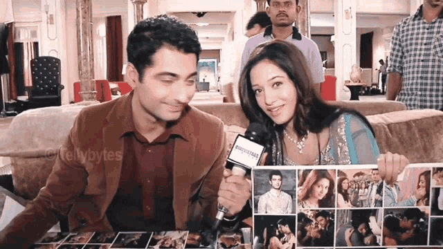 a man and a woman are sitting on a couch and the woman is holding a collage of photos