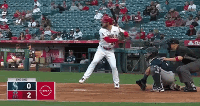a baseball game is being played with a scoreboard that says nissan