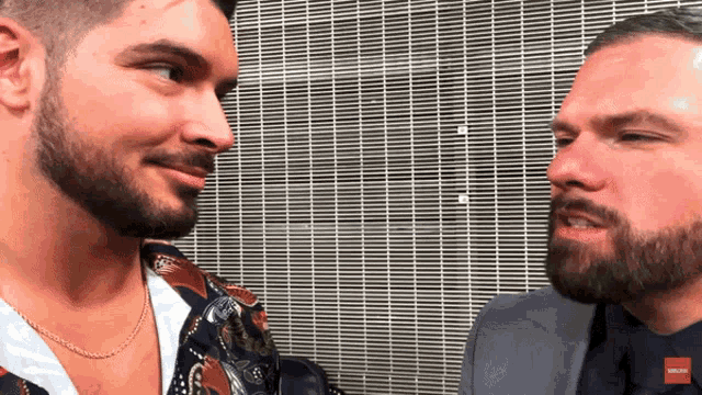 a man with a beard is talking to another man with a beard