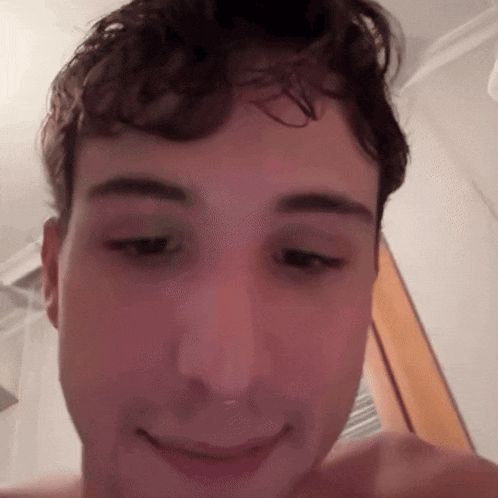 a close up of a man 's face with a smile