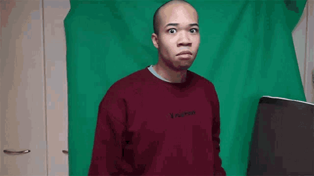 a man wearing a maroon sweater with playboy on it