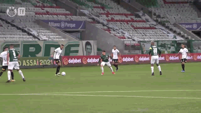 a group of soccer players on a field with a banner that says allianz parque in the background
