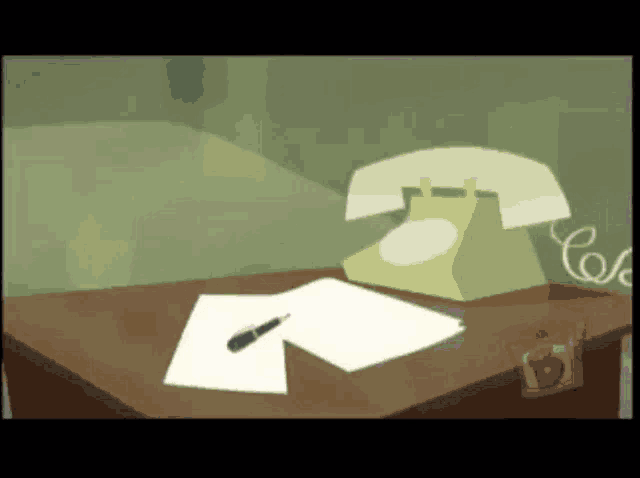a phone sits on a desk next to a piece of paper with a pen on it