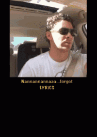 a man wearing sunglasses and a white shirt is sitting in the back seat of a car ..