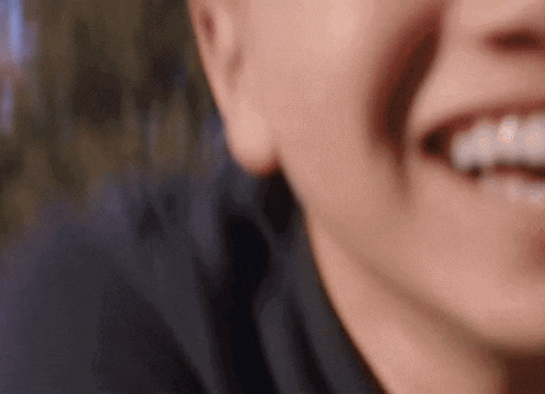 a close up of a person 's face with a smile on it