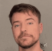 a close up of a man 's face with a beard .
