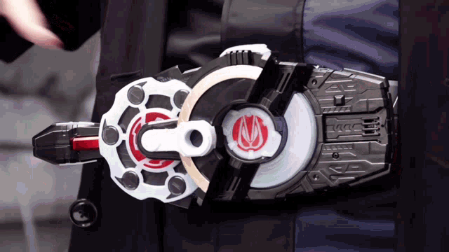 a person is wearing a belt that has a red s on it