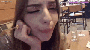 a woman with a ring on her finger is sitting at a table