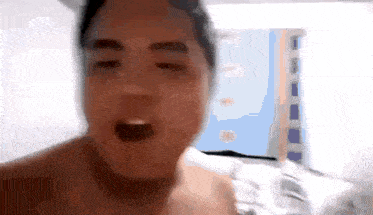 a blurry picture of a shirtless man with his mouth open