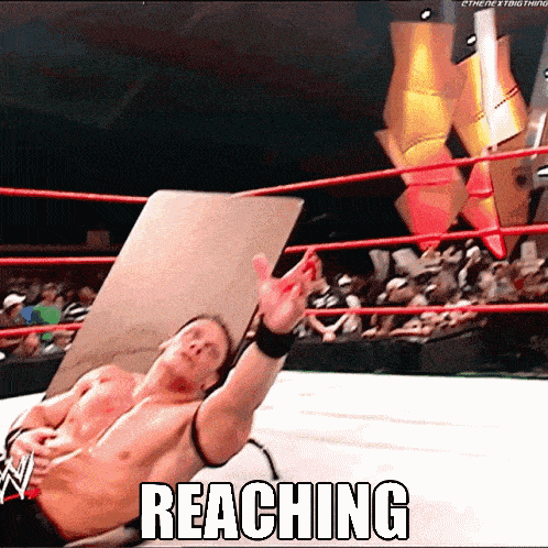 a shirtless wrestler in a wrestling ring with the word reaching below him