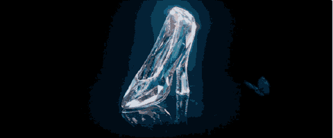 a glass shoe with a butterfly on it on a black background