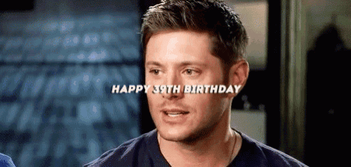 a man in a blue shirt is smiling and says `` happy 39th birthday '' .