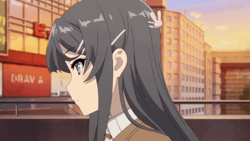a girl with long hair stands in front of a building that says drav a