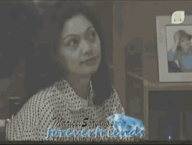 a woman is sitting in front of a picture and the words foreverfriends are on the bottom