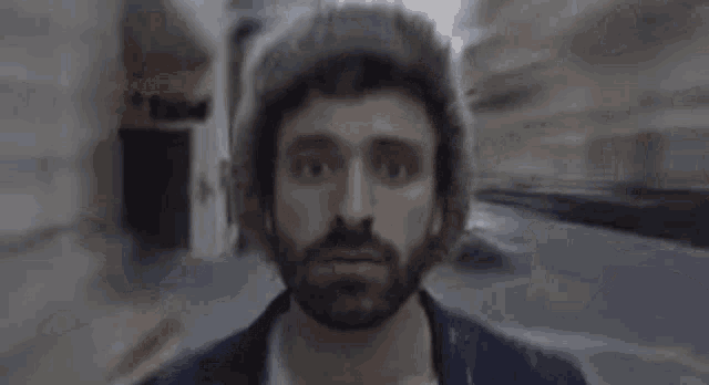 a man with a beard is wearing a fur hat .