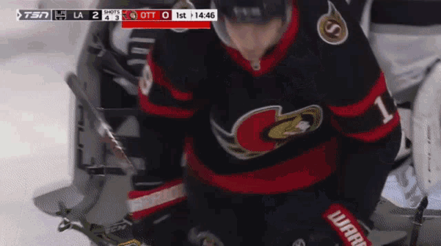 a hockey player with the number 1 on his jersey stands on the ice