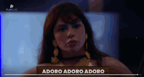 a woman is standing in front of a sign that says adore adore adore