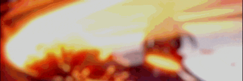a close up of a fire with a lot of flames coming out of it .