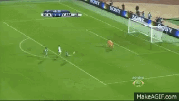 a man in a suit is dancing on a soccer field .