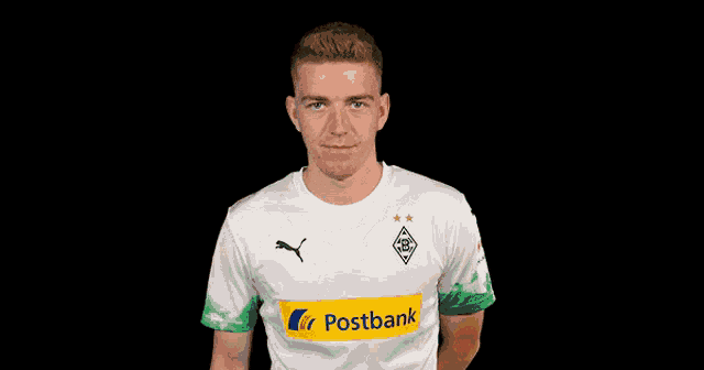 a man wearing a white shirt with postbank on the sleeve