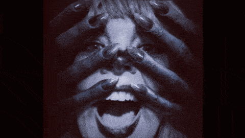 a close up of a person 's face with their hands on it