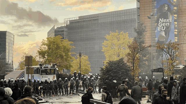 a crowd of people are gathered in front of a building with a sign that says next gen eu