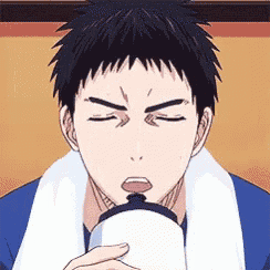 a man with a towel around his neck is drinking from a white cup .