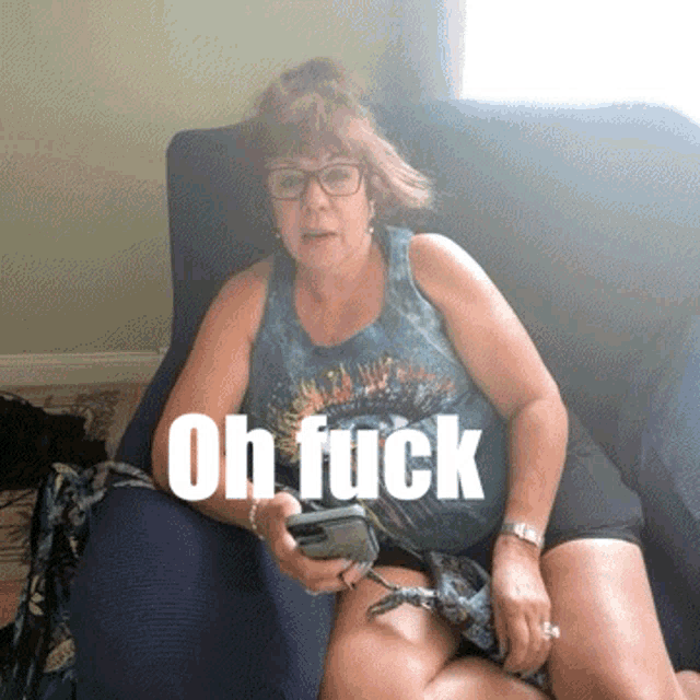 a woman sitting on a couch with the words oh fuck written on the bottom
