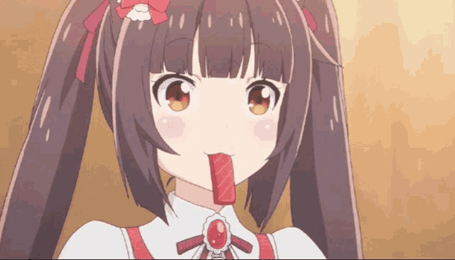 a girl with a bow on her head is eating a candy
