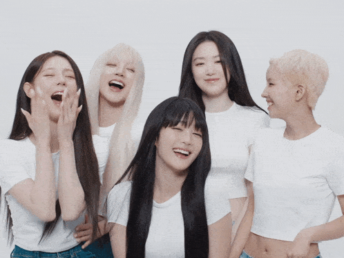 a group of young women are posing for a picture and one of them is laughing