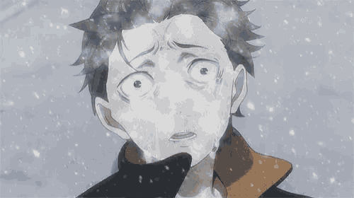 a boy is standing in the snow in front of a castle in the snow .