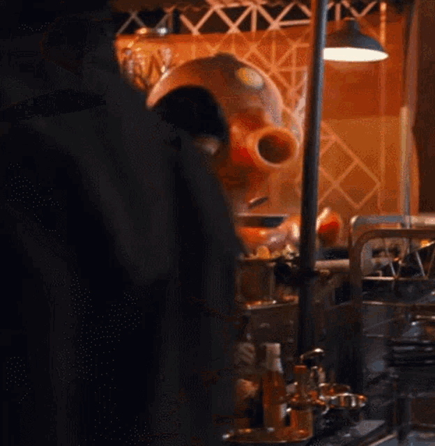 a man in a black hat prepares food in a restaurant kitchen