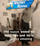 a man is holding a sign that says victory royale .