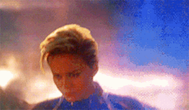 a close up of a person 's face with a purple background .