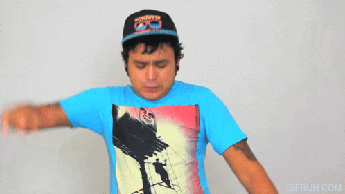a man wearing a blue shirt with a picture of a billboard and a vonepper hat