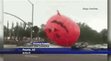 a red balloon with a face on it is being caught on camera in peoria az