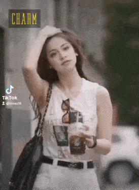 a woman in a white tank top with the word charm on the bottom