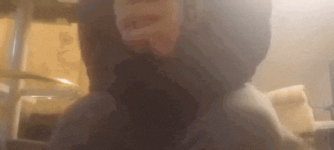 a close up of a person 's face with smoke coming out of their mouth .