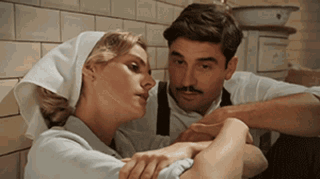 a man and a woman are hugging each other in a room