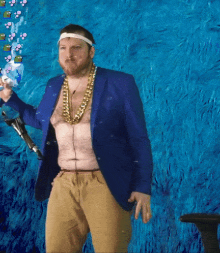 a shirtless man in a blue jacket and gold chains