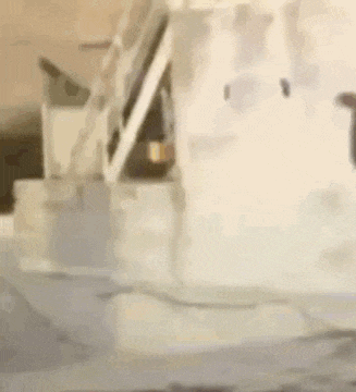 a man is standing in front of a machine that is making ice .