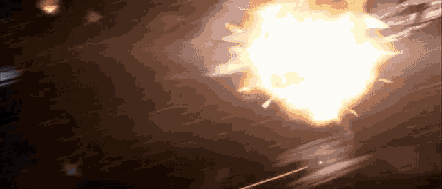 a large explosion is taking place in a dark room with a red light coming out of it .