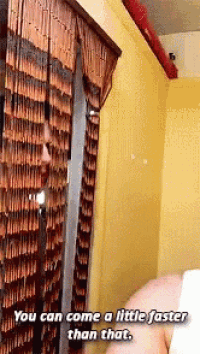 a man is standing in front of a wooden curtain with the words " you can come a little faster than that "