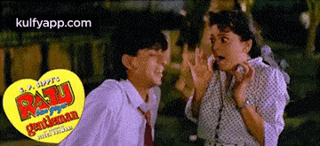 a man and a woman are standing next to each other in front of a sign that says raju gentleman