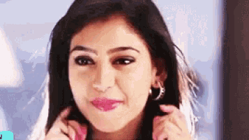 a close up of a woman 's face with a slight smile on her face .